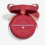 “Open red Christmas bauble gift box showing ‘A Little Wish’ bracelet inside”
