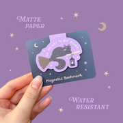Hand holding a Witch Cat magnetic bookmark by Hopscotch Paper Co.