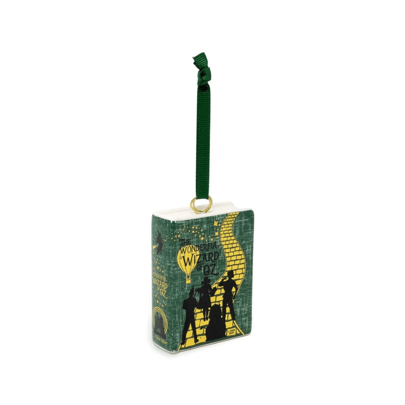 Angled view of the Wizard of Oz ceramic book Christmas decoration showing its green cover and illustrated spine