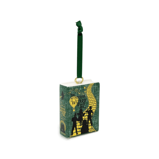 Angled view of the Wizard of Oz ceramic book Christmas decoration showing its green cover and illustrated spine