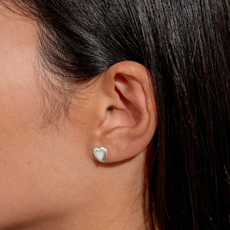 “Lifestyle image – silver heart stud earring worn in ear lobe”

