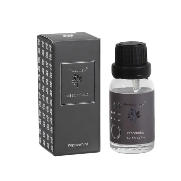 Woodbridge Peppermint essential oil bottle beside its matching black branded box.