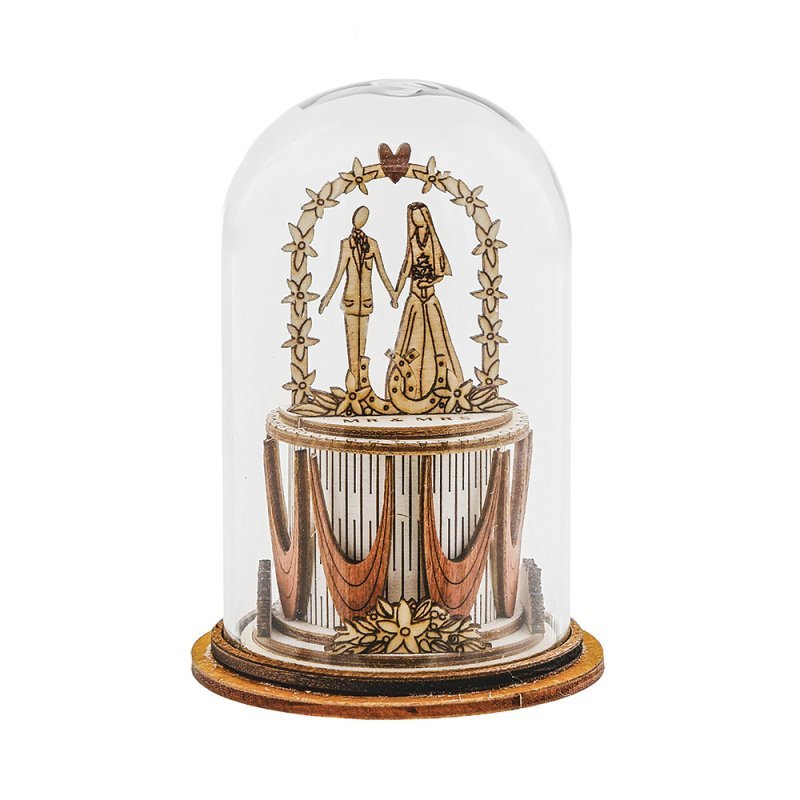 Wooden wedding couple under floral arch in glass-style dome from Tiny Town