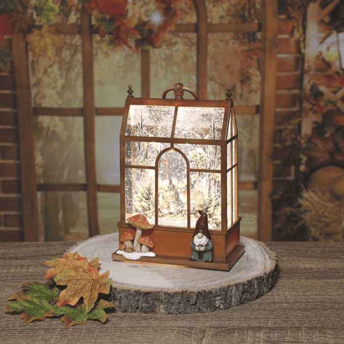 Lit Gonk House water spinner on a wooden slice with autumn leaves, glowing glitter and woodland scene.