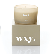 Frosted pale grey glass WXY bed candle displayed on a matching WXY box on a white background.
