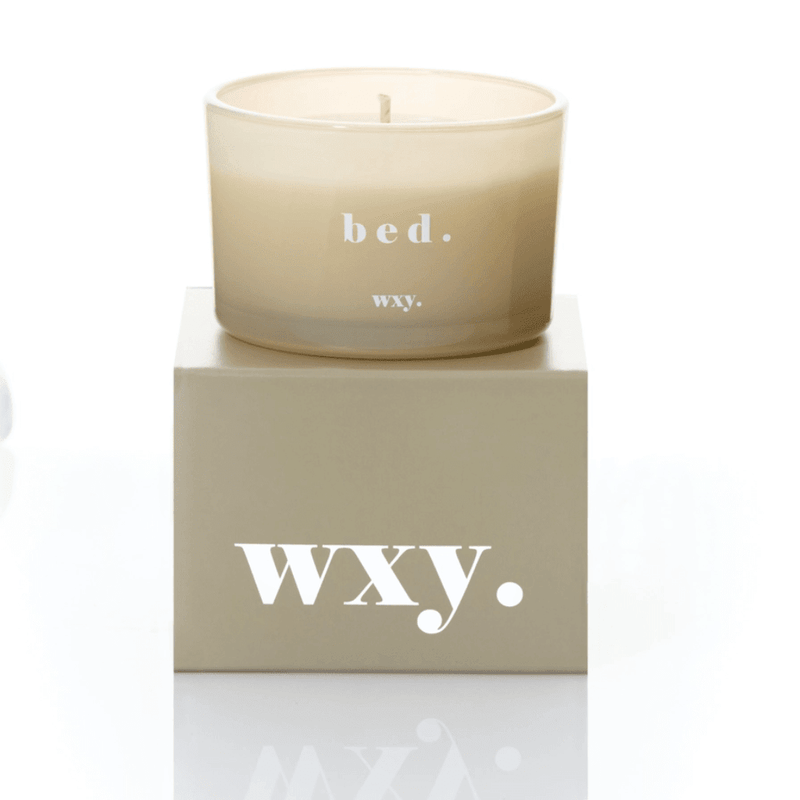 Frosted pale grey glass WXY bed candle displayed on a matching WXY box on a white background.