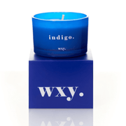 Blue glass WXY indigo candle displayed on a matching WXY box on a white background.