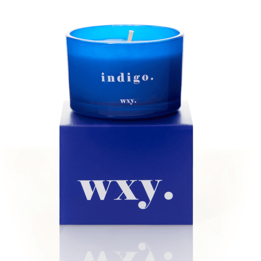 Blue glass WXY indigo candle displayed on a matching WXY box on a white background.