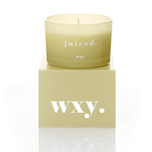 Pale green frosted glass WXY juiced candle displayed on a matching WXY box on a white background.