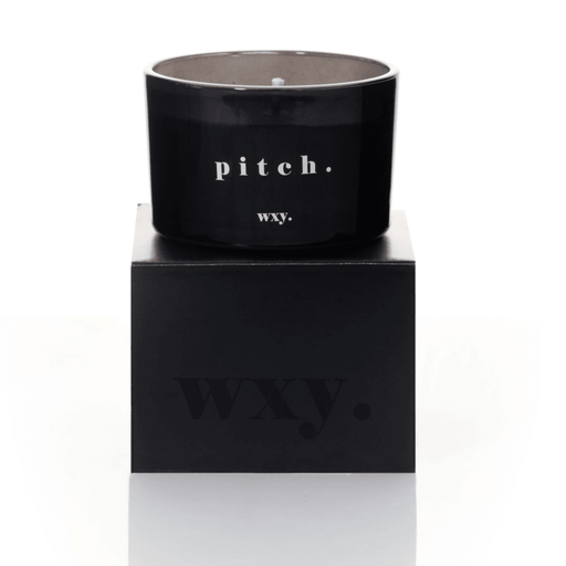 Black glass WXY pitch candle displayed on a matching black WXY box on a white background.