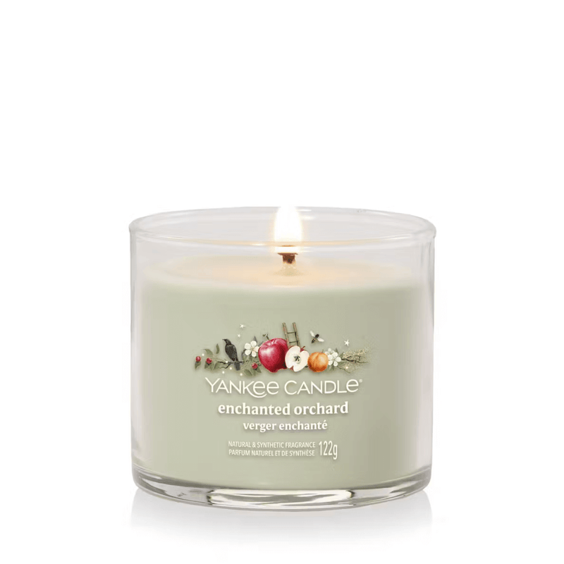 Yankee Candle Enchanted Orchard Signature tumbler scented candle lit, soft green wax, product image on white