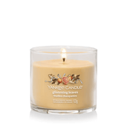 Yankee Candle Glistening Leaves Signature tumbler scented candle lit, warm amber wax, product image on white