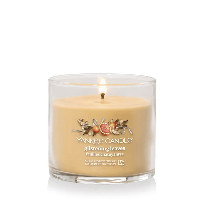 Yankee Candle Glistening Leaves Signature tumbler scented candle lit, warm amber wax, product image on white