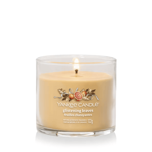 Yankee Candle Glistening Leaves Signature tumbler scented candle lit, warm amber wax, product image on white