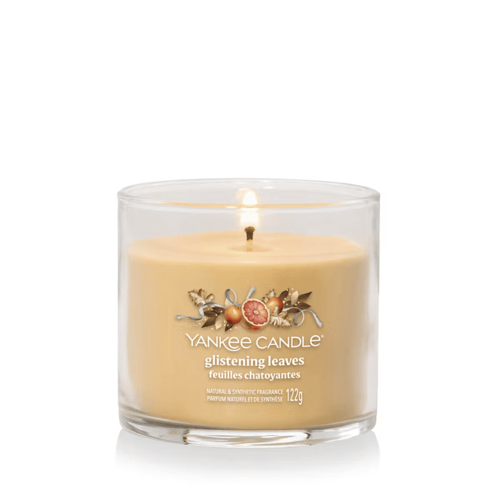 Yankee Candle Glistening Leaves Signature tumbler scented candle lit, warm amber wax, product image on white