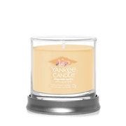 Slopeside Spritz small tumbler candle on round metal stand with soft orange wax