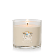 Vanilla Flurries small tumbler lit, creamy vanilla wax in clear glass