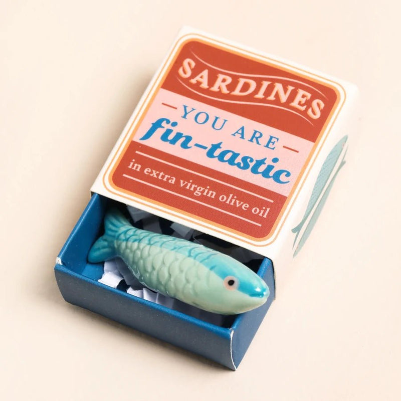 Open sardine tin matchbox with mini ceramic sardine token inside and You are fin-tastic message on lid